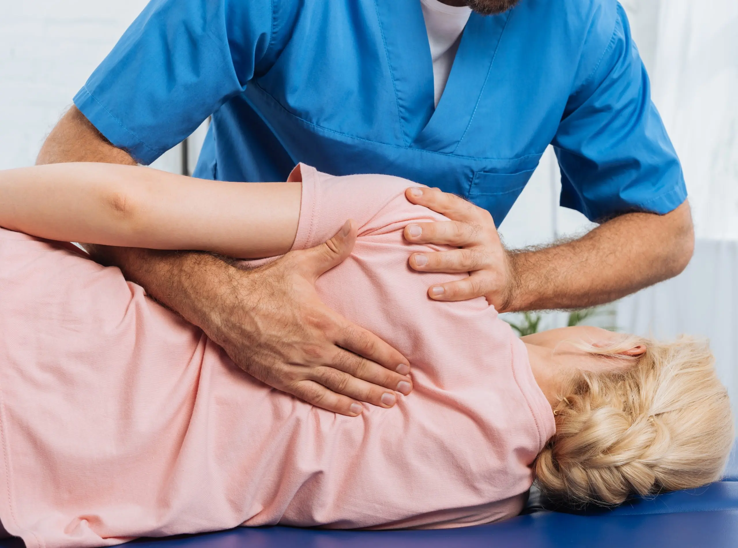 cropped-shot-of-chiropractor-massaging-back-of-pat-2023-11-27-05-24-25-utc